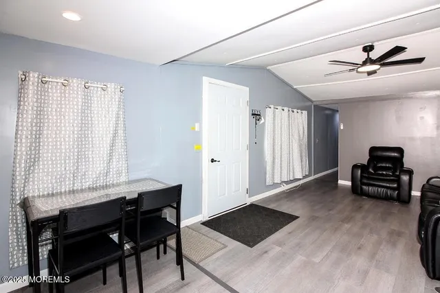 a kitchen with a dining table chairs and refrigerator