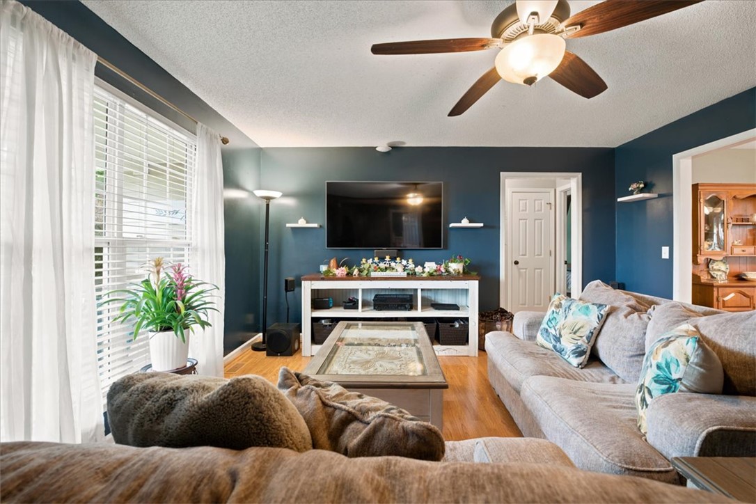 520 Sharon Lane Seneca, SC 29678 - Photo 11 of 48 Hardwood floors and a warm ceiling fan define this inviting living space.