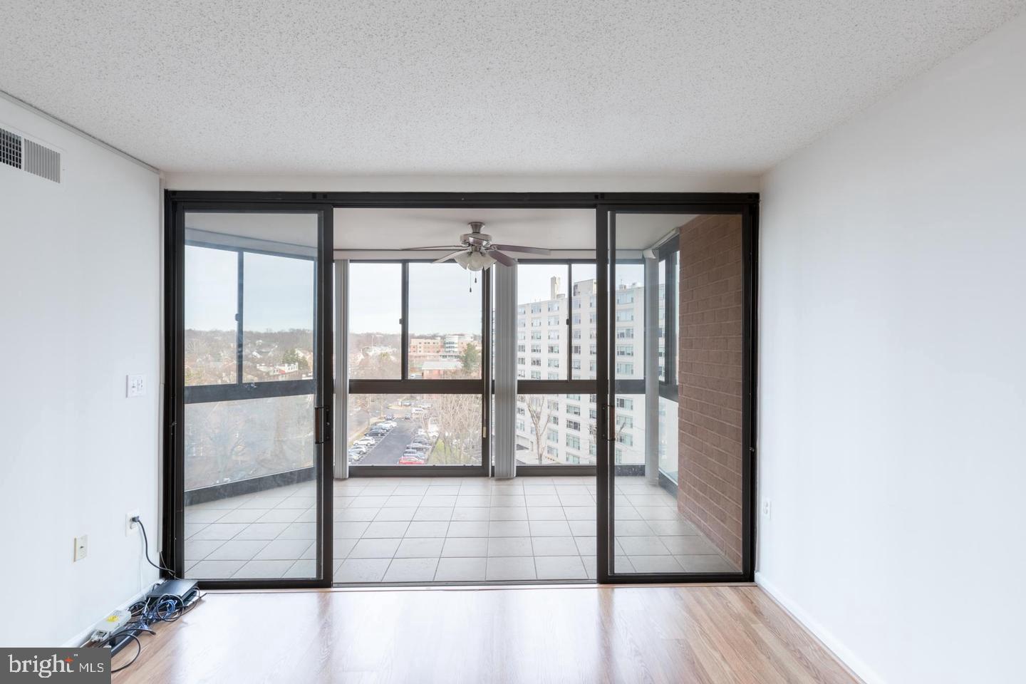 1001 North Randolph Street, Unit 811 Arlington, VA 22201 - Photo 11 of 30 a view of empty room with wooden floor and fan