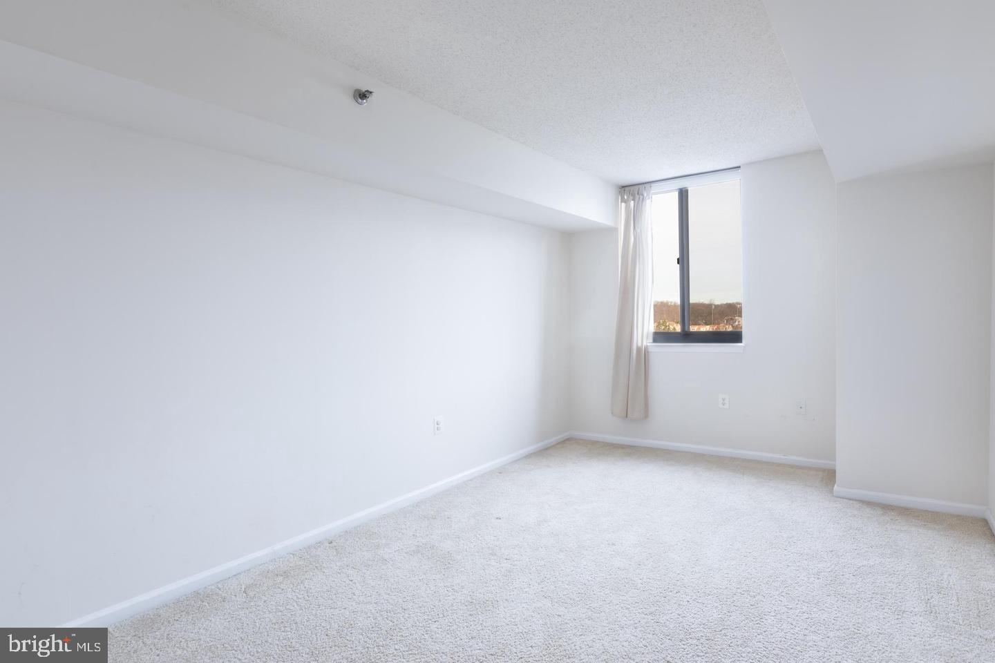 1001 North Randolph Street, Unit 811 Arlington, VA 22201 - Photo 20 of 30 a view of an empty room with a window