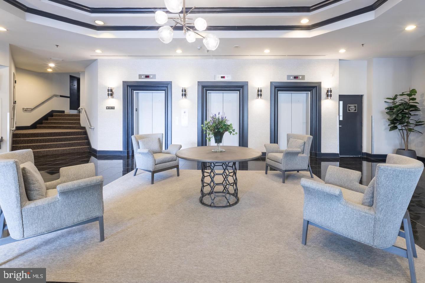 1001 North Randolph Street, Unit 811 Arlington, VA 22201 - Photo 26 of 30 a living room with furniture and a chandelier