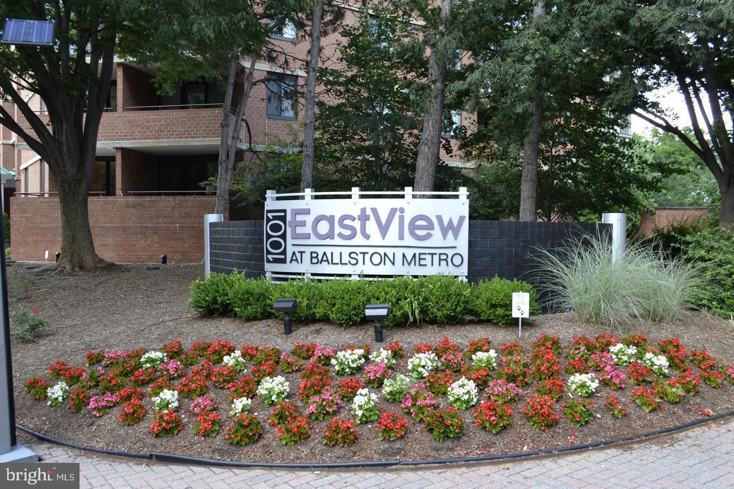 1001 North Randolph Street, Unit 811 Arlington, VA 22201 - Photo 30 of 30 a sign that is sitting in front of flowers