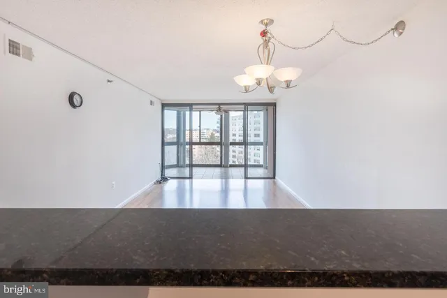 a view of a room with wooden floor