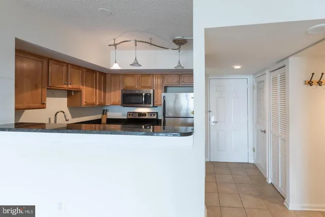 a kitchen with stainless steel appliances a sink a stove and a refrigerator