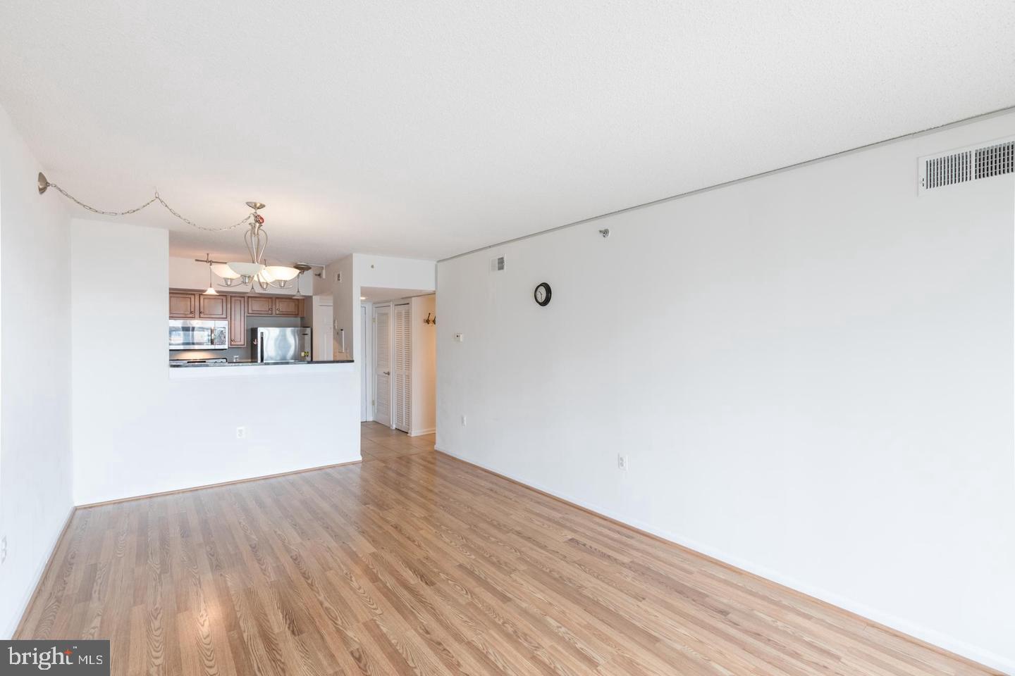 1001 North Randolph Street, Unit 811 Arlington, VA 22201 - Photo 9 of 30 a view of an empty room with wooden floor