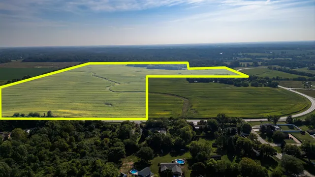 a view of a swimming pool with an outdoor seating and a yard