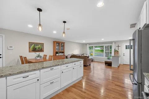 a spacious bathroom with a granite countertop sink and mirror