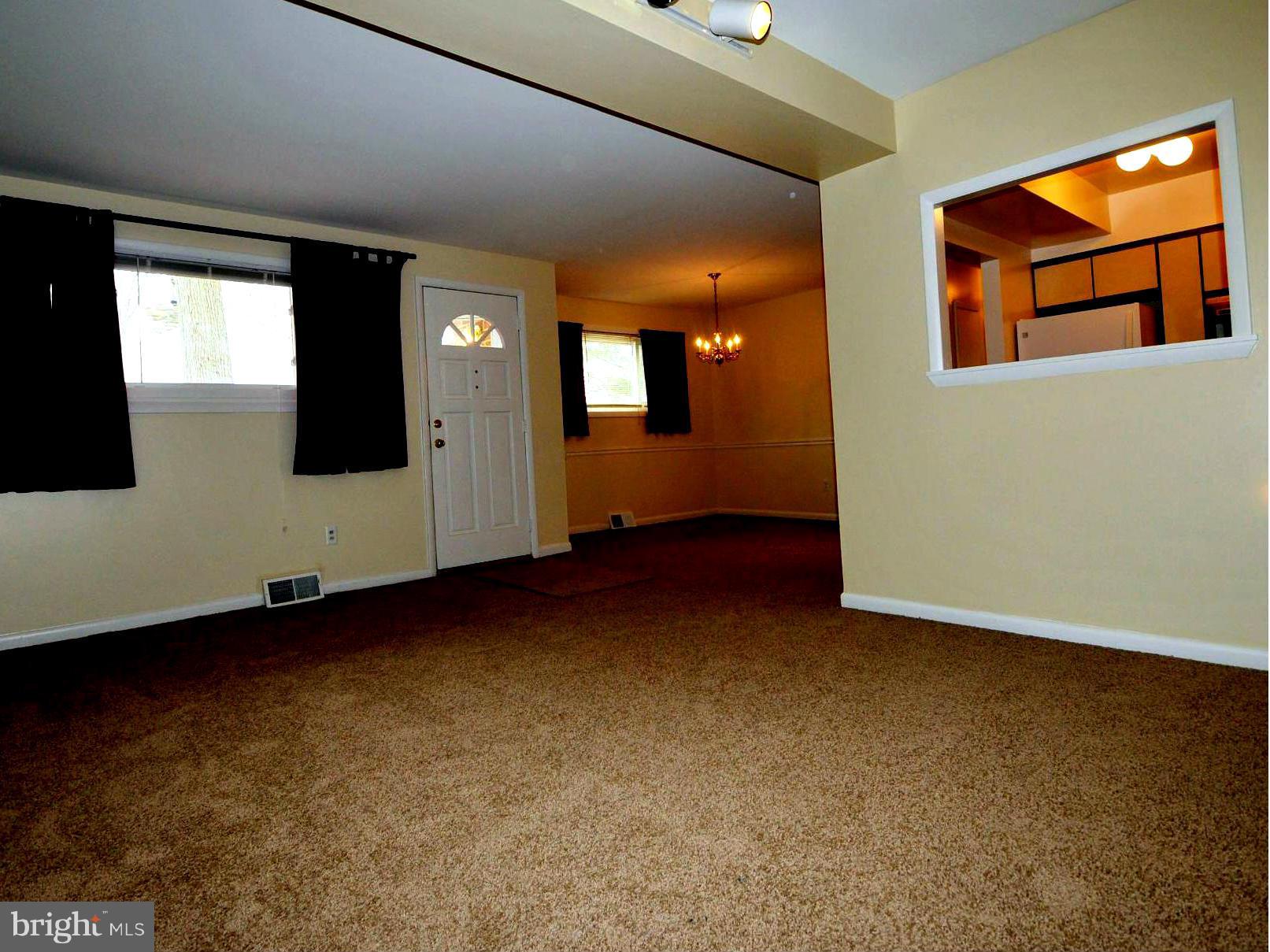 505 Epsom Road, Unit TA Towson, MD 21286 - Photo 3 of 11 a view of an empty room with window and wooden floor