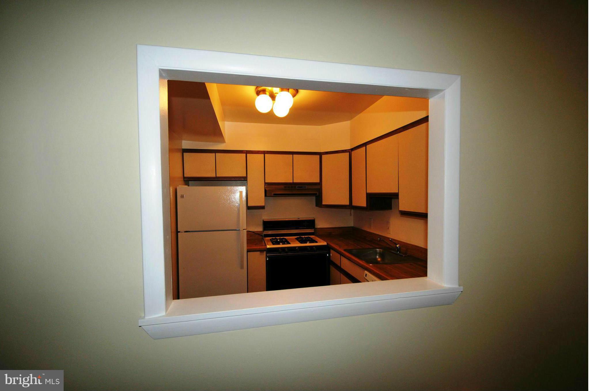 505 Epsom Road, Unit TA Towson, MD 21286 - Photo 5 of 11 a kitchen with a refrigerator and a sink