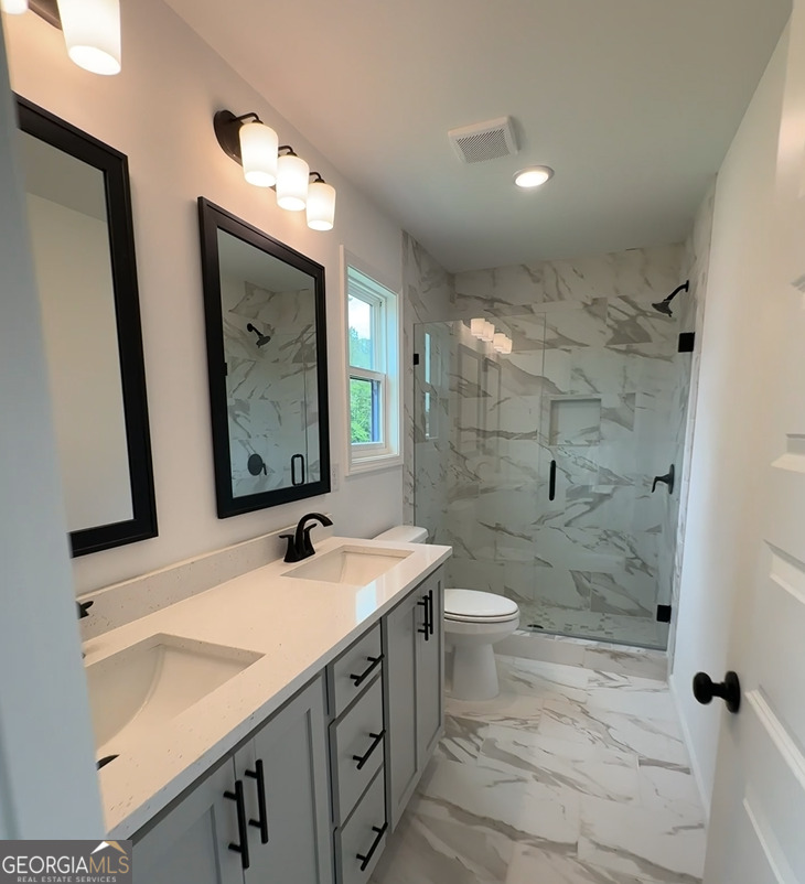 109 Burns Road Carrollton, GA 30117 - Photo 10 of 14 a bathroom with a double vanity sink mirror and toilet