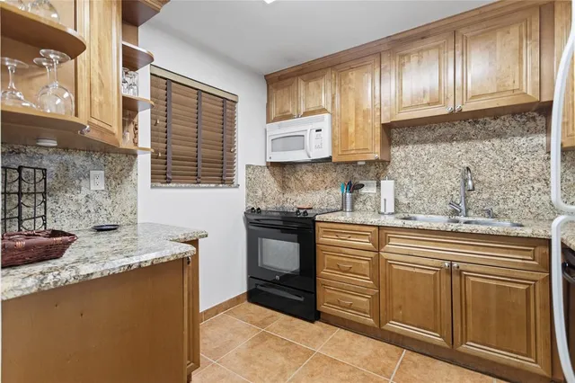 a kitchen with a refrigerator a stove a sink and a window