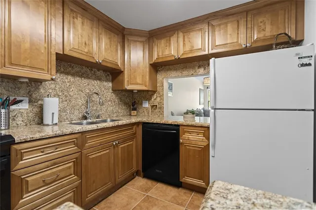 a kitchen with stainless steel appliances granite countertop a refrigerator sink stove microwave and cabinets