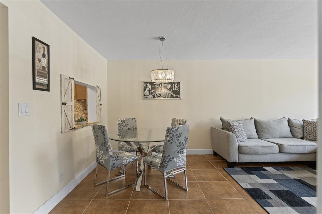 2312 South Cypress Bend Drive, Unit 205 Pompano Beach, FL 33069 - Photo 21 of 61 a dining room with furniture and window