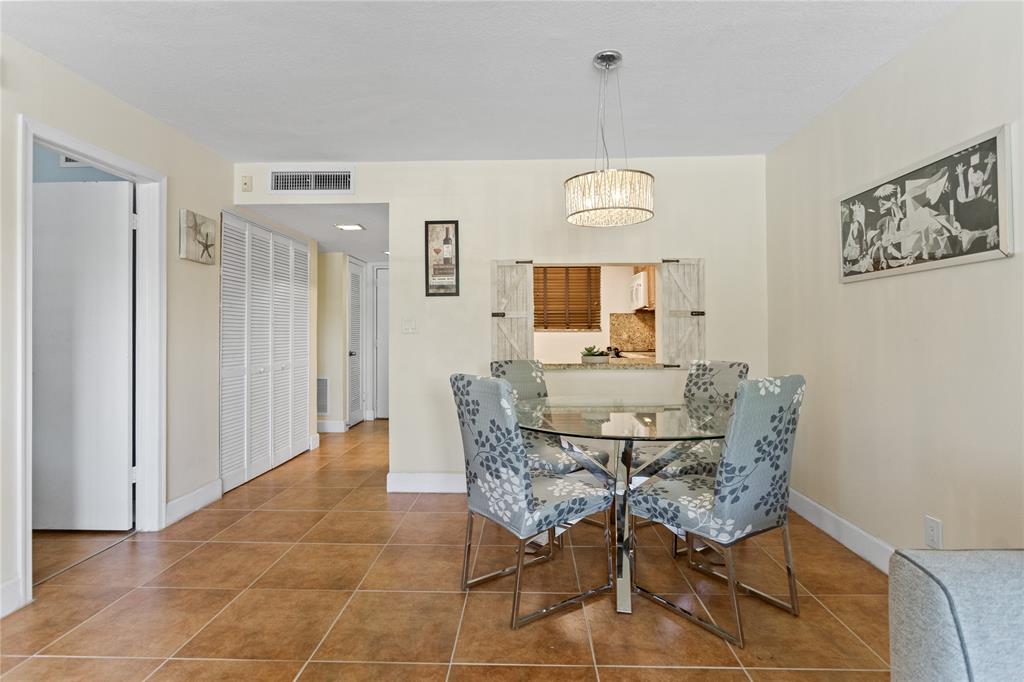 2312 South Cypress Bend Drive, Unit 205 Pompano Beach, FL 33069 - Photo 22 of 61 a view of a dining room with furniture