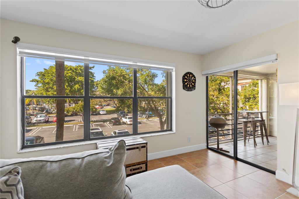 2312 South Cypress Bend Drive, Unit 205 Pompano Beach, FL 33069 - Photo 27 of 61 a living room with furniture and windows