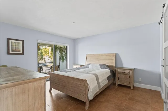 a bedroom with a bed a stove and a window