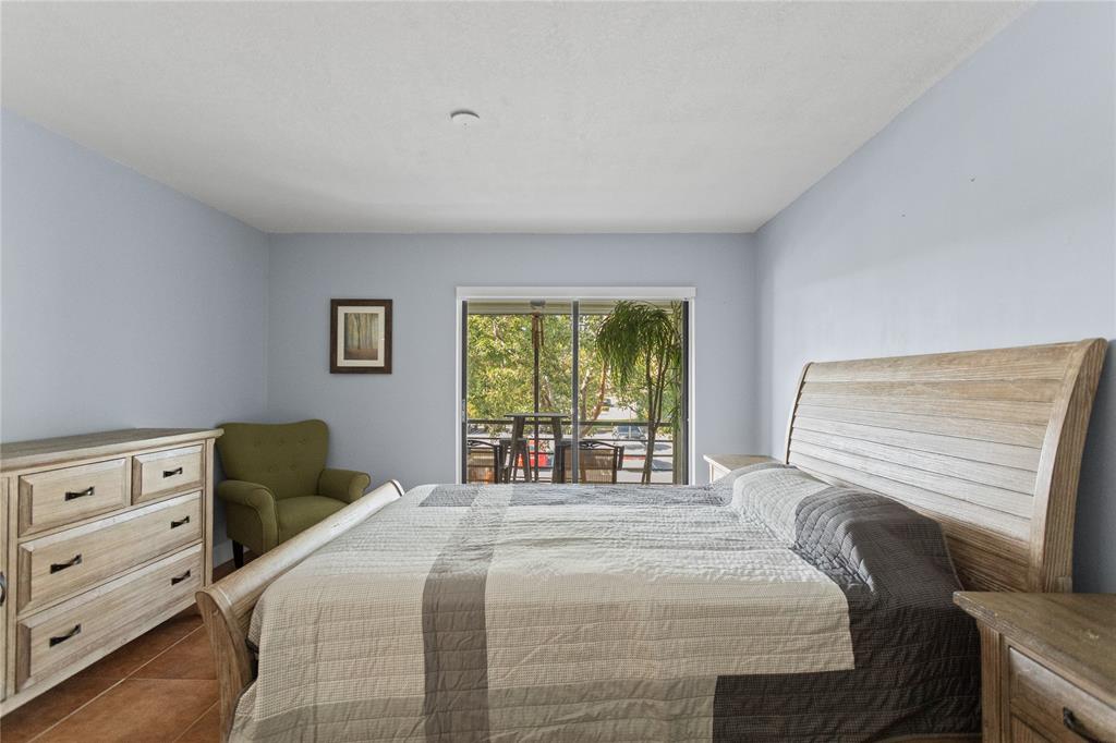 2312 South Cypress Bend Drive, Unit 205 Pompano Beach, FL 33069 - Photo 32 of 61 a bedroom with a bed and a window