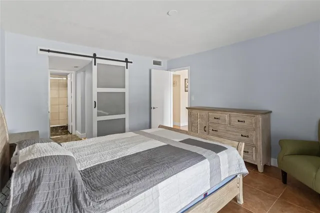 a en suite bathroom with a granite countertop sink and a mirror
