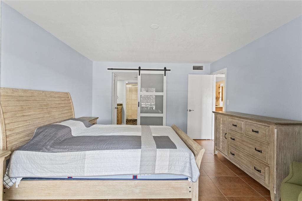 2312 South Cypress Bend Drive, Unit 205 Pompano Beach, FL 33069 - Photo 35 of 61 a large white bed in a white room