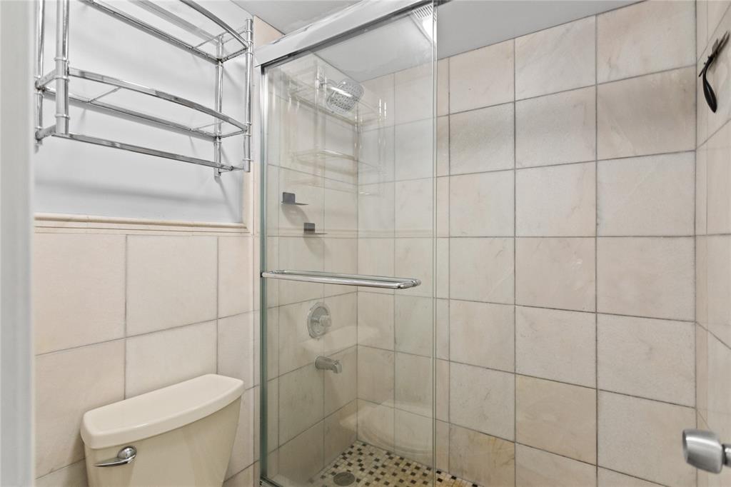 2312 South Cypress Bend Drive, Unit 205 Pompano Beach, FL 33069 - Photo 39 of 61 a bathroom with a toilet and shower