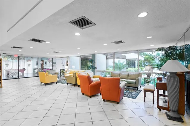 a room with gym equipment and large windows