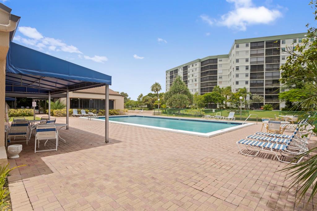2312 South Cypress Bend Drive, Unit 205 Pompano Beach, FL 33069 - Photo 48 of 61 a view of a swimming pool with a patio
