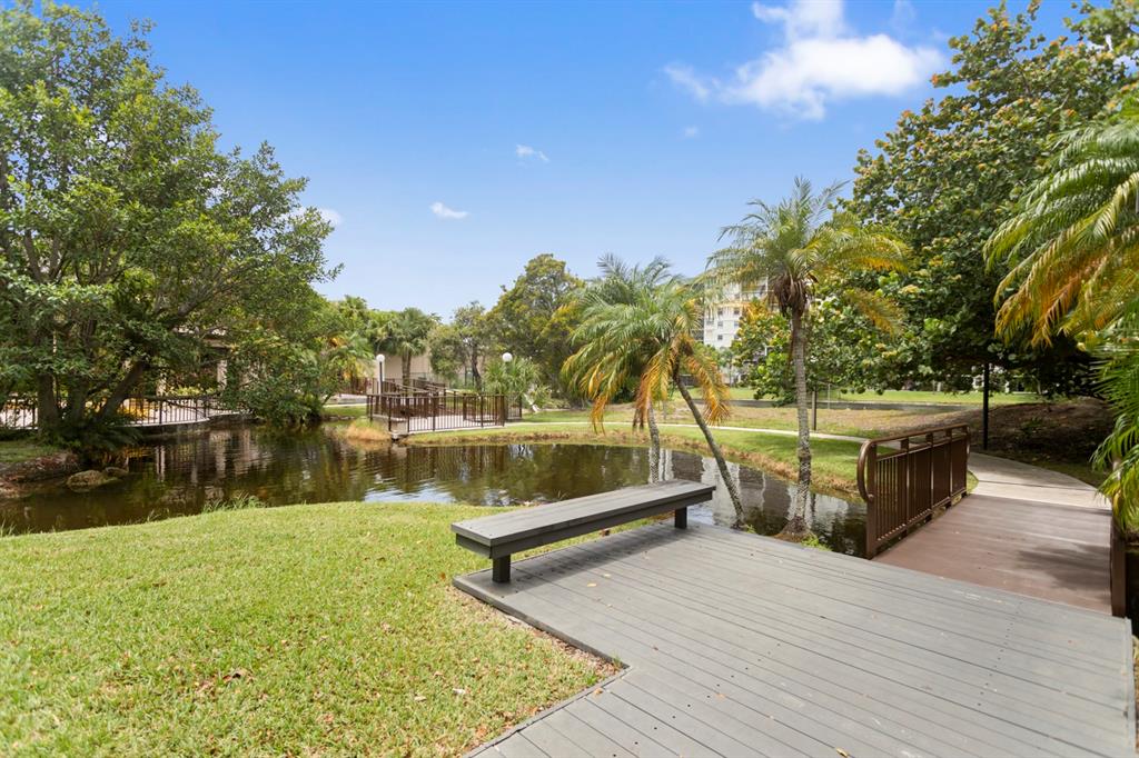 2312 South Cypress Bend Drive, Unit 205 Pompano Beach, FL 33069 - Photo 54 of 61 a view of a lake with houses in the background