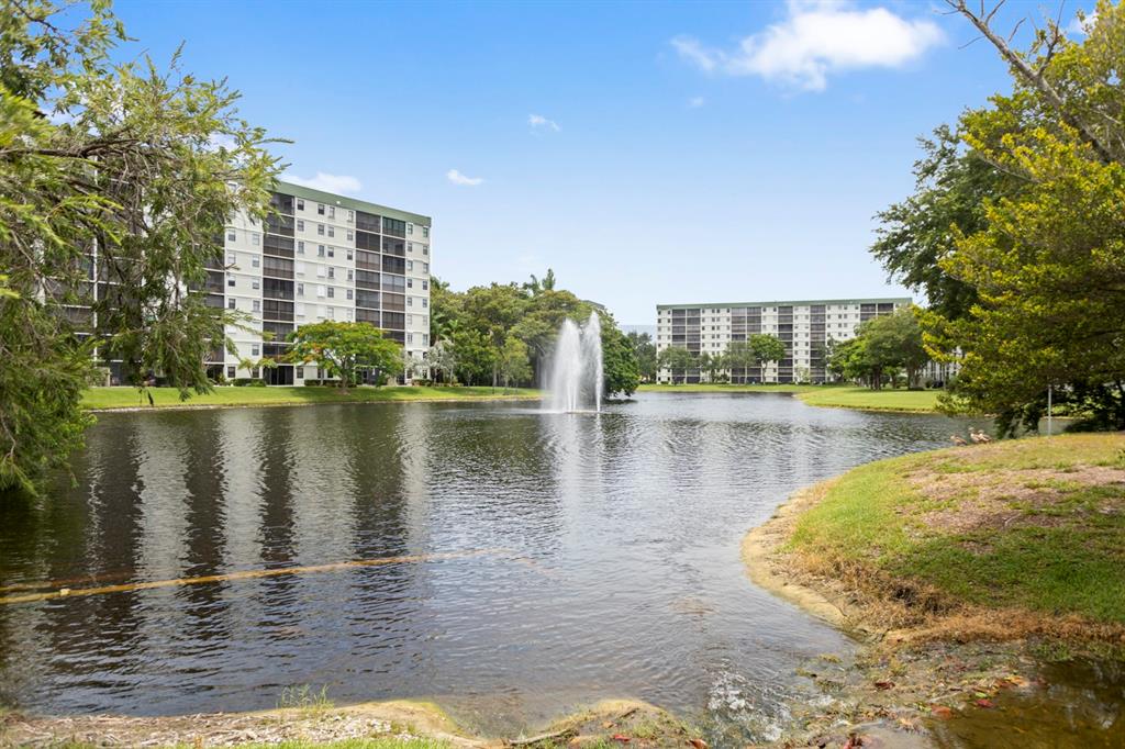 2312 South Cypress Bend Drive, Unit 205 Pompano Beach, FL 33069 - Photo 55 of 61 a view of a lake with building in front of it
