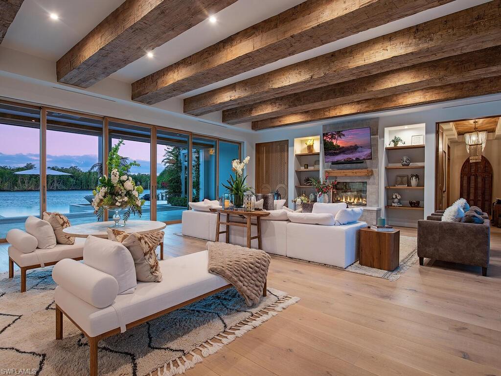 860 Admiralty Parade Naples, FL 34102 - Photo 11 of 45 a living room with furniture and a large window