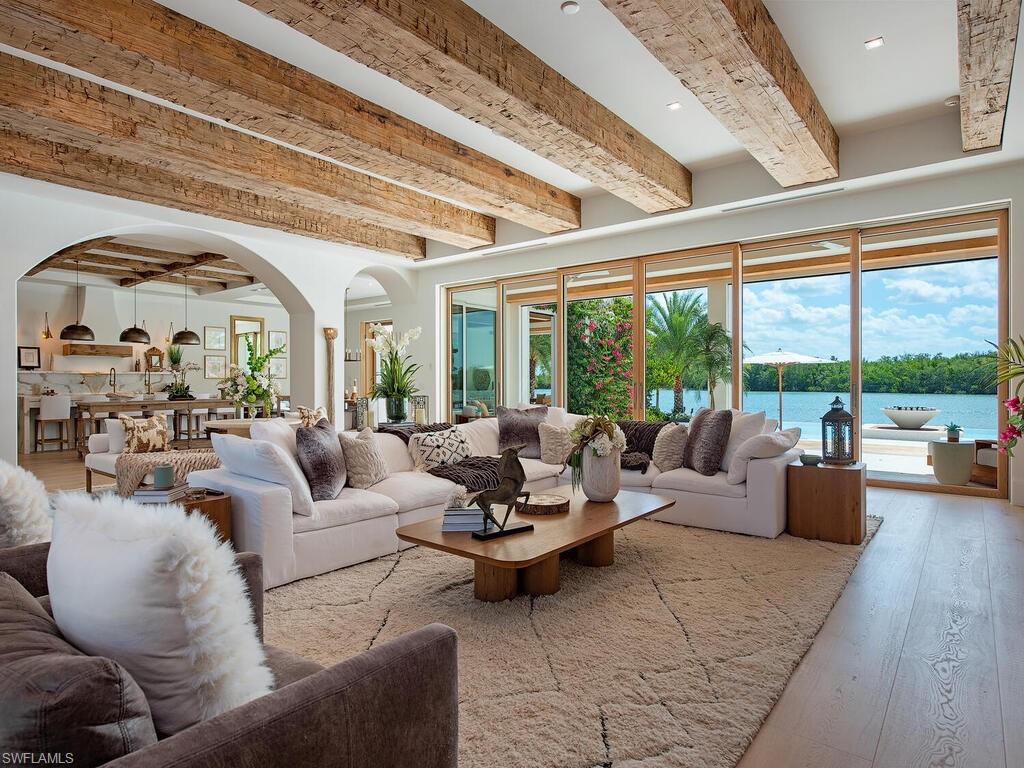 860 Admiralty Parade Naples, FL 34102 - Photo 12 of 45 a living room with furniture and a large window