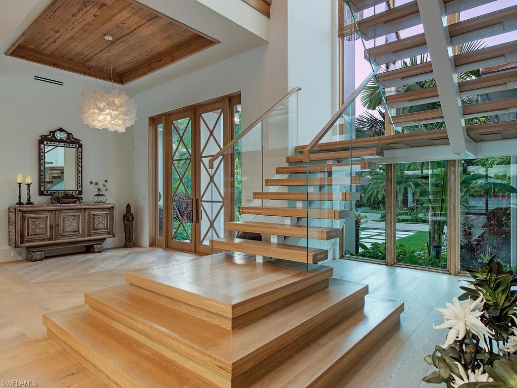 860 Admiralty Parade Naples, FL 34102 - Photo 13 of 45 a living room with furniture and a large window