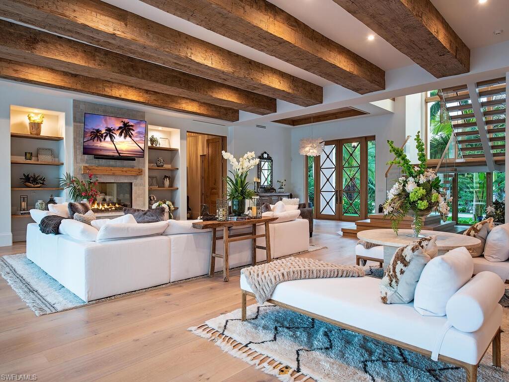 860 Admiralty Parade Naples, FL 34102 - Photo 21 of 45 a living room with fireplace furniture and a large window