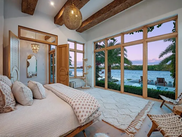 a bedroom with a large bed and a large window