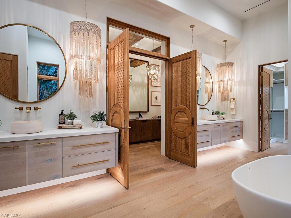 860 Admiralty Parade Naples, FL 34102 - Photo 23 of 45 a spacious bathroom with a double vanity sink a mirror and a shower