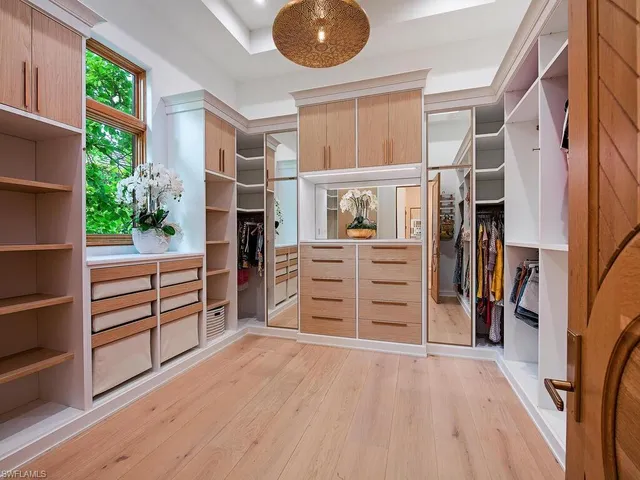 an empty room with furniture and wooden floor