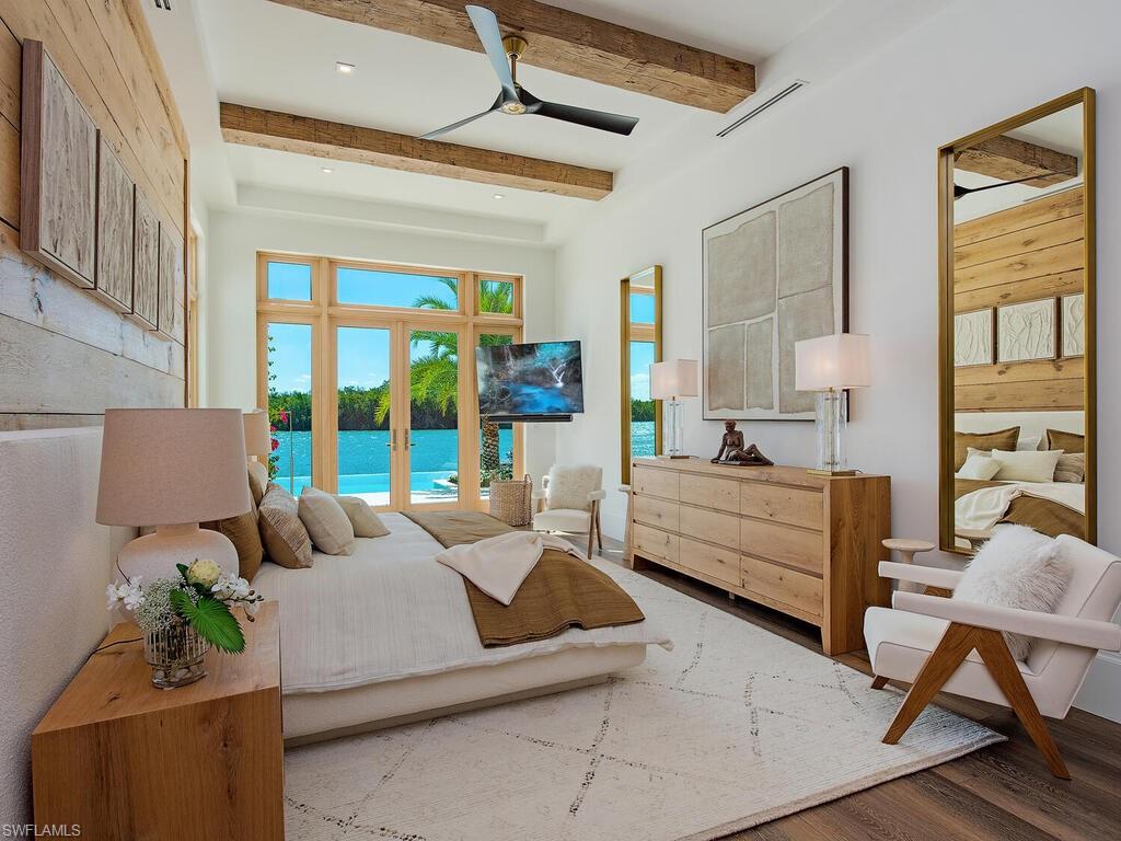 860 Admiralty Parade Naples, FL 34102 - Photo 27 of 45 a living room with furniture and large windows