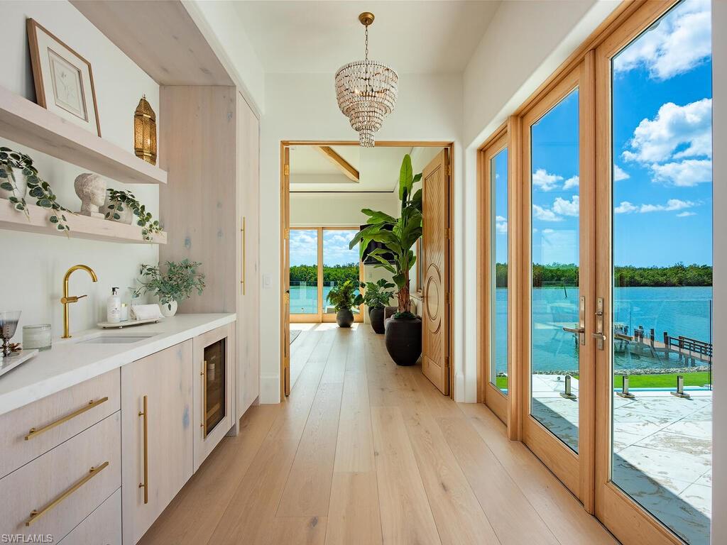 860 Admiralty Parade Naples, FL 34102 - Photo 29 of 45 a spacious bathroom with a balcony a sink and a large mirror
