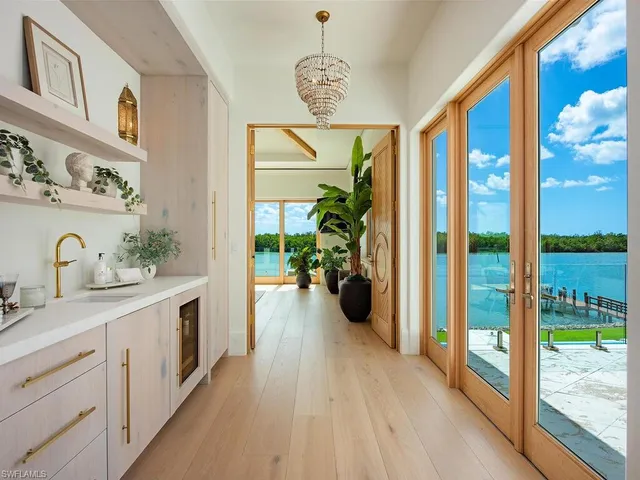 a spacious bathroom with a balcony a sink and a large mirror