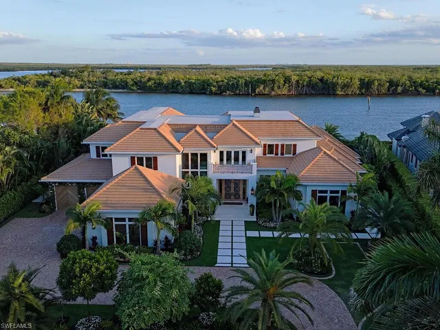 an aerial view of house with yard and lake view