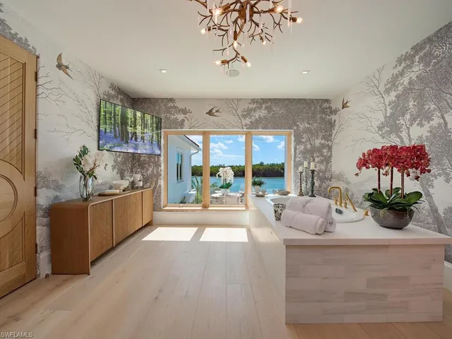 a living room with furniture and a floor to ceiling window