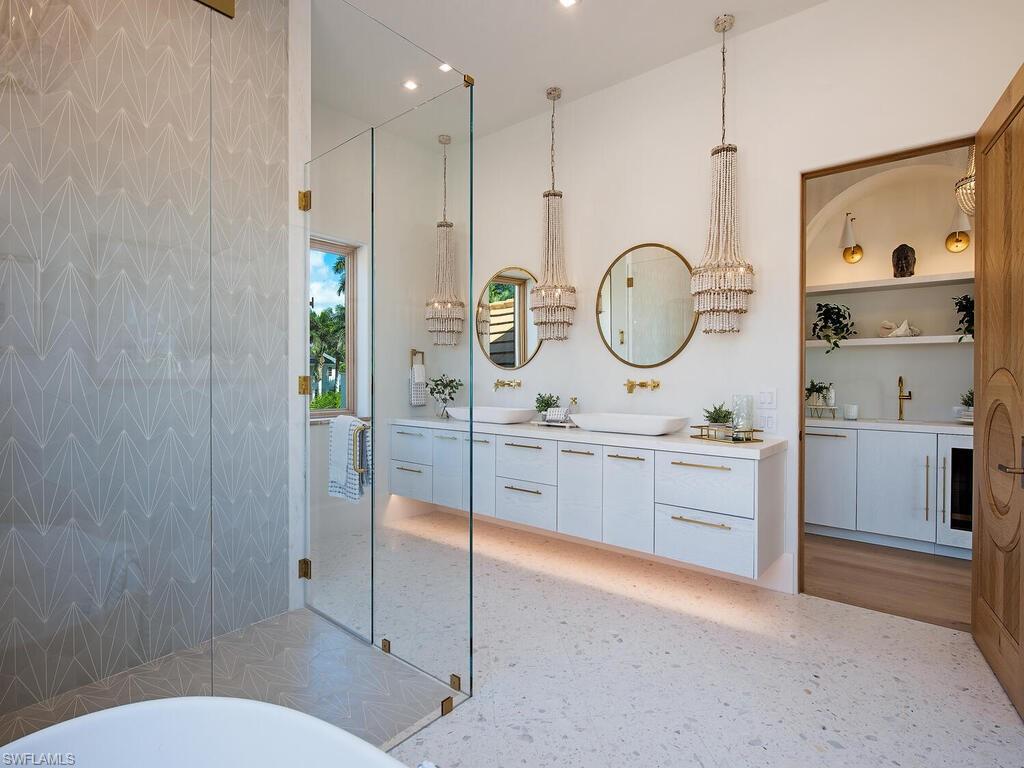 860 Admiralty Parade Naples, FL 34102 - Photo 34 of 45 a bathroom with a toilet a sink a mirror and a shower