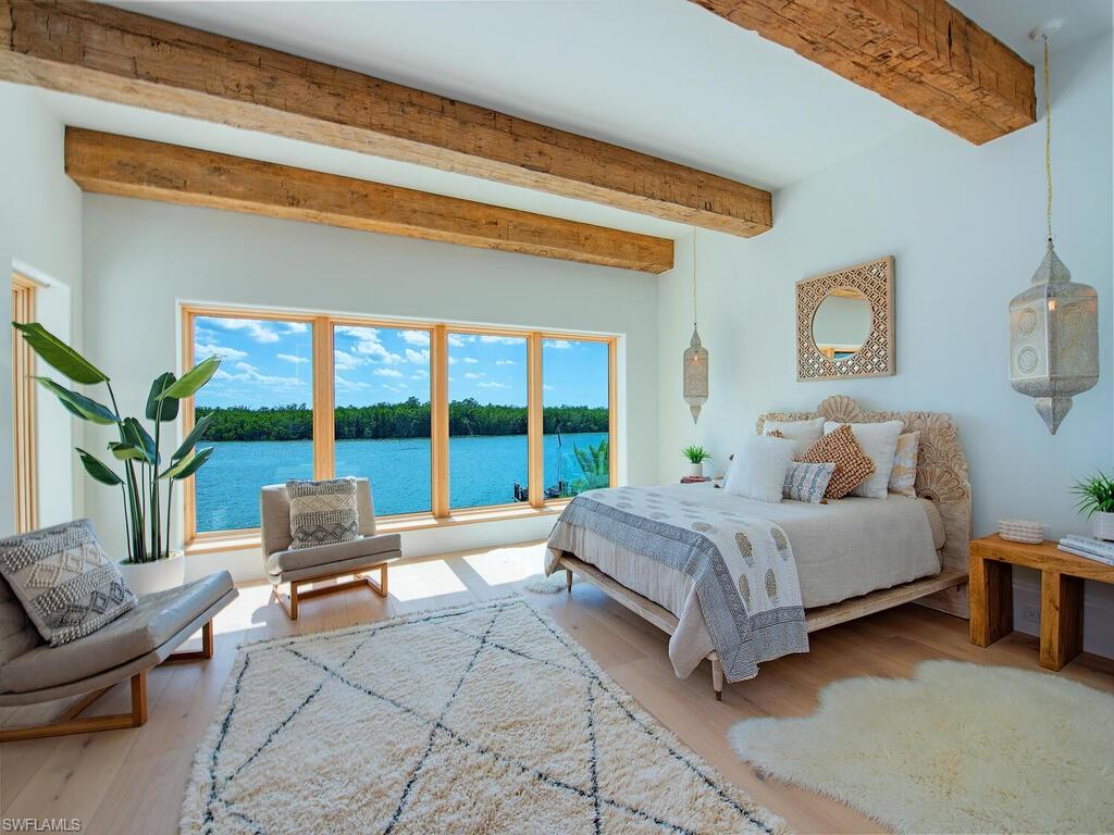 860 Admiralty Parade Naples, FL 34102 - Photo 35 of 45 a spacious bedroom with a bed and a couch