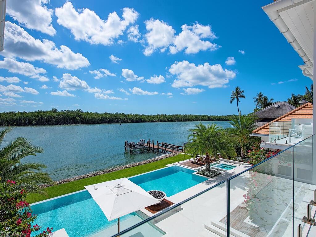 860 Admiralty Parade Naples, FL 34102 - Photo 40 of 45 a view of a lake with couches and city view