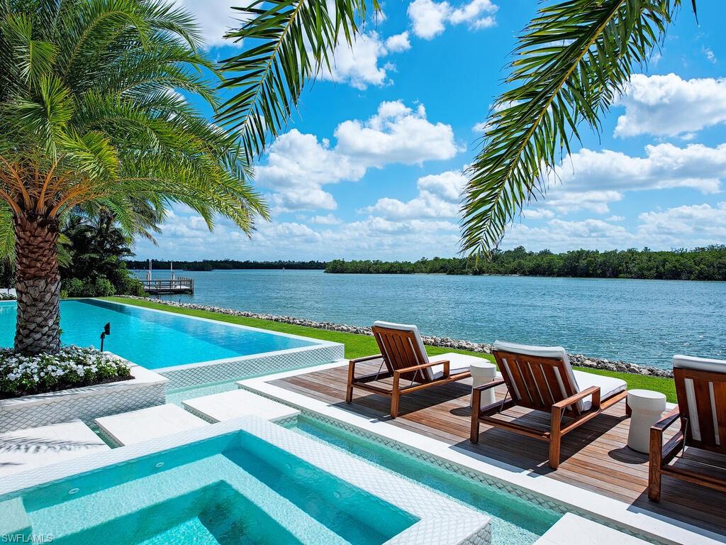 860 Admiralty Parade Naples, FL 34102 - Photo 41 of 45 a view of a lake with table and chairs