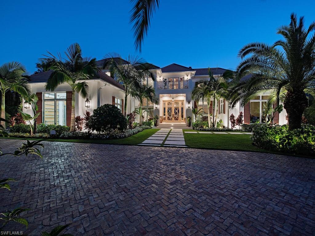 860 Admiralty Parade Naples, FL 34102 - Photo 7 of 45 a front view of a house with garden