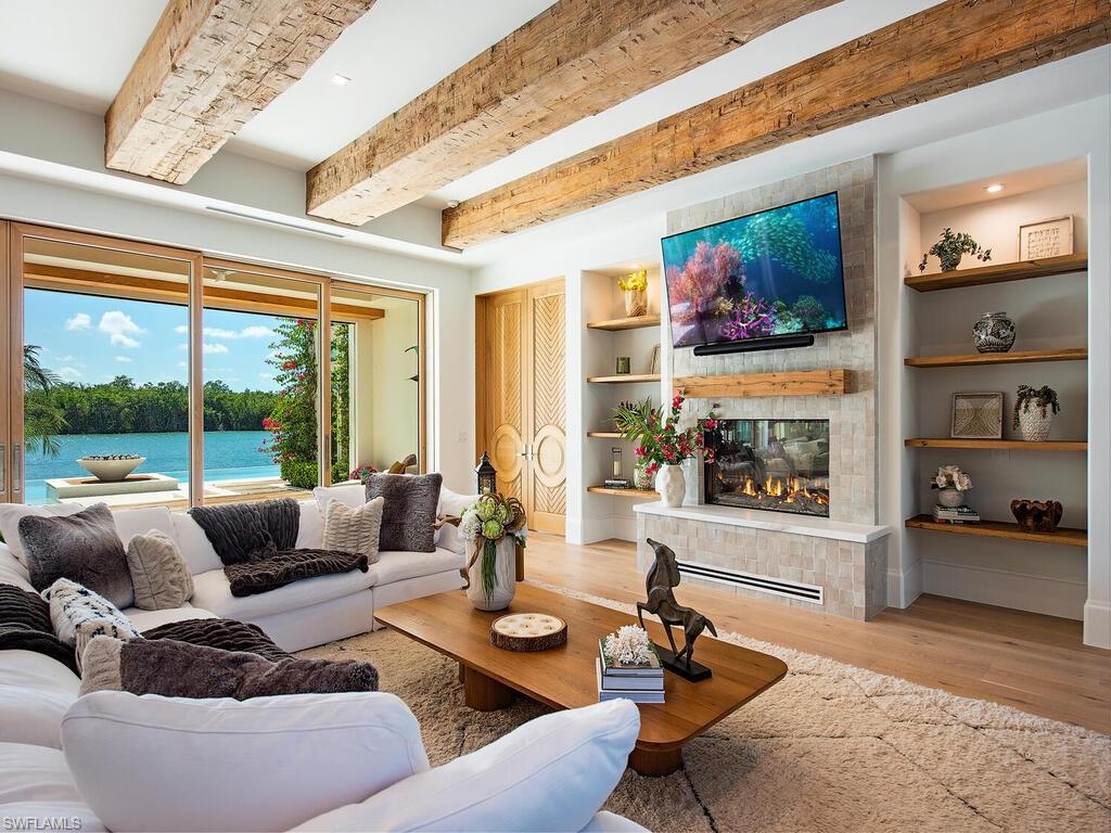 860 Admiralty Parade Naples, FL 34102 - Photo 10 of 45 a living room with furniture and a large window