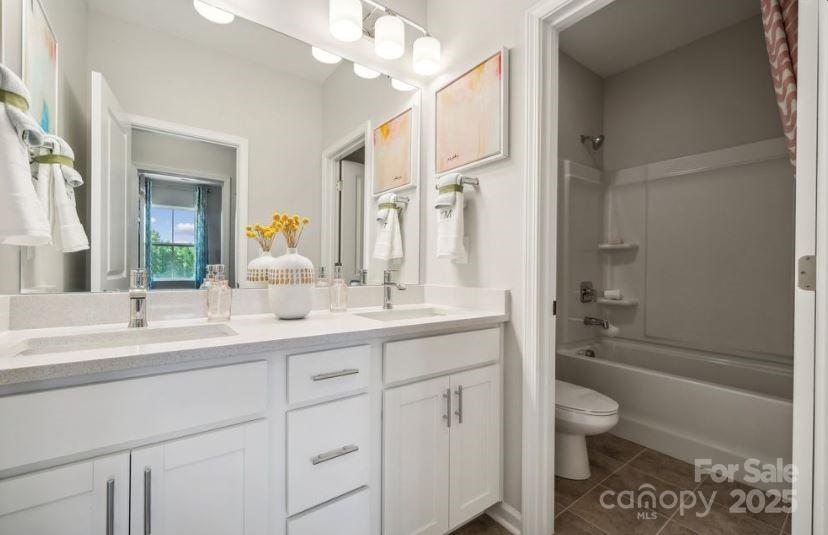 8664 Miles Gap Road Indian Land, SC 29707 - Photo 12 of 29 a bathroom with a toilet a sink a tub and a mirror