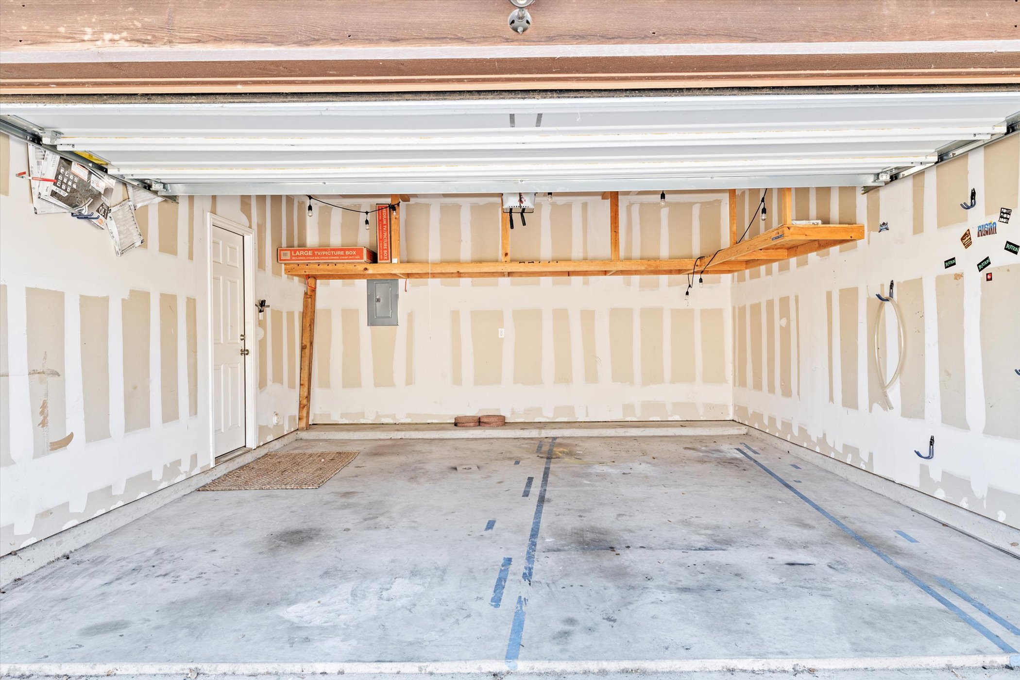 7337 Menchaca Road, Unit #22 Austin, TX 78745 - Photo 21 of 25 2 car garage featuring electric panel and extra space for storage