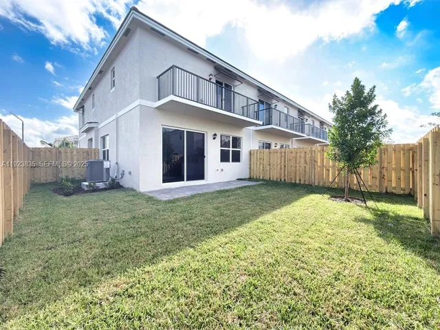 a view of a backyard with sitting area