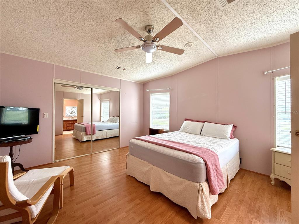 222 North St George Circle Apollo Beach, FL 33572 - Photo 11 of 33 a bedroom with a bed window and a flat screen tv
